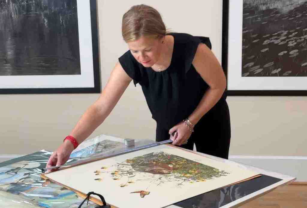 Appraiser evaluating artwork during fine art appraisal in St. Louis, Missouri